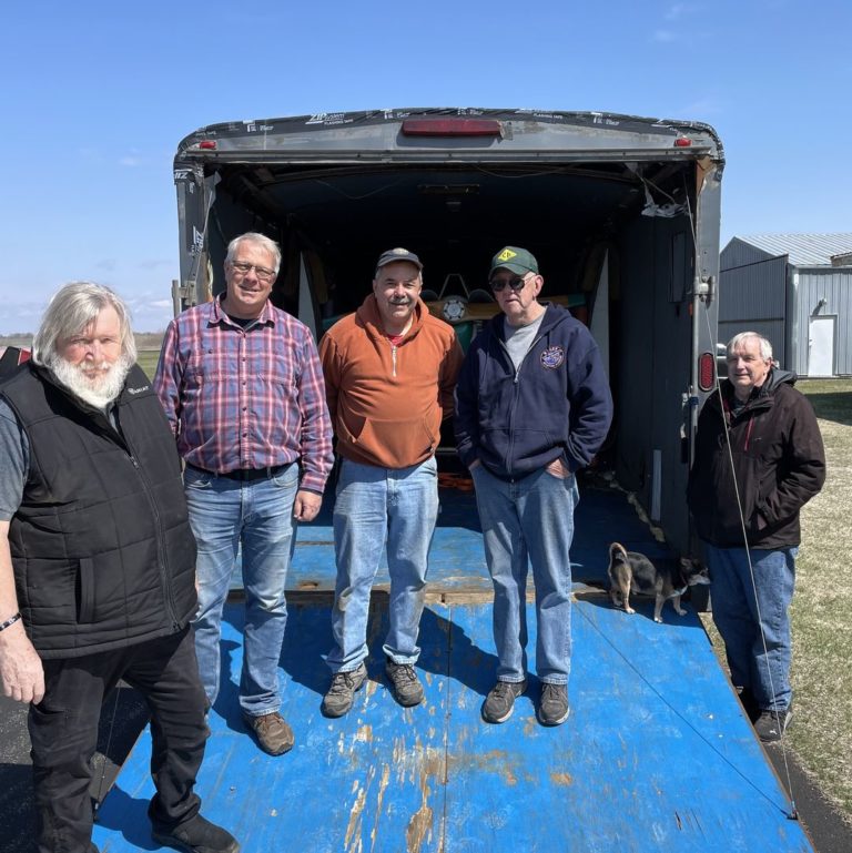 Volunteer Mark Buehl (L) helping transport an aircraft.